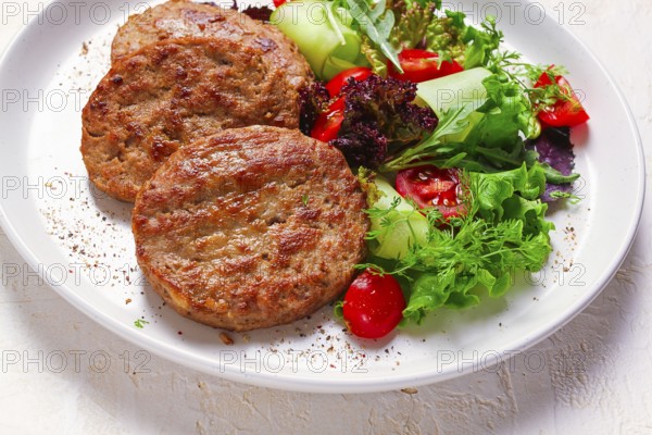 Fried cutlets, turkey, with vegetable salad, top view, no people