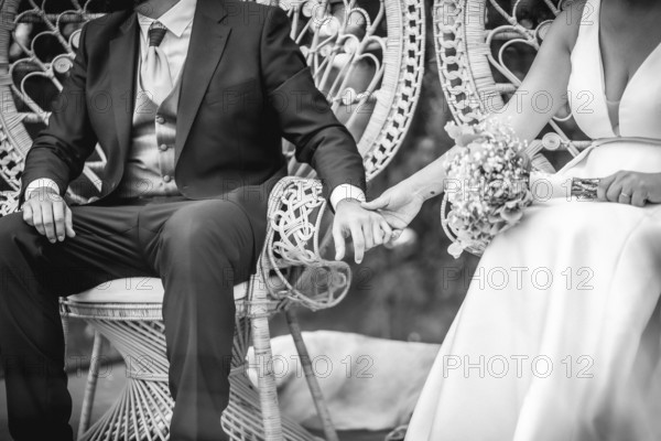 Newlywed couple holding hands, celebrating their love and commitment on their wedding day