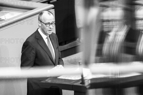 Berlin, Germany - 18 March 2025: Friedrich Merz, CDU Chairman and Chancellor-designate, speaks in the Bundestag in front of the vote on reforming the debt brake to allow hundreds of billions of euros to be borrowed for defence, infrastructure and climate protection, which requires a two-thirds majority of MPs to amend the Basic Law. The SPD and CDU/CSU had introduced the bill to amend the Basic Law in special sessions in the old Bundestag and put it to the vote due to different majorities in the new Bundestag, which will be constituted next week. Note: the photo was subsequently converted to b/w