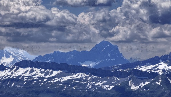 View of impressive mountain range with snow-covered peaks under dramatic clouds, Oberstaufen, Bavaria, Germany, Europe