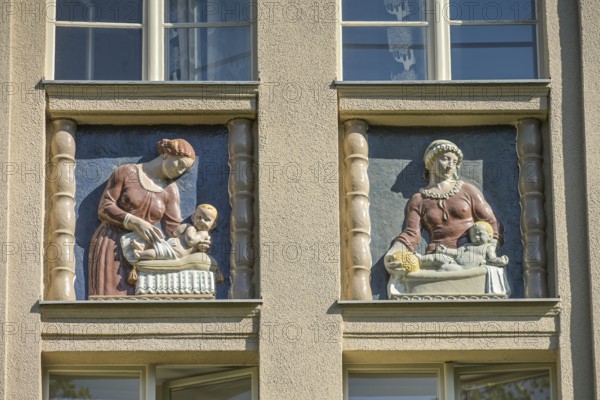 Mothers looking after their babies, relief on an old building, former woman's and children's clinic, today St. Marien residential park, Mariendorfer Weg, Neukölln, Berlin, Germany, Europe