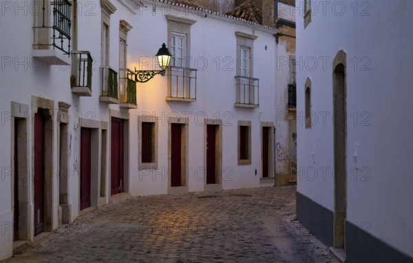 Winding alley, Rua Monsenhor Boto, alleyway lamp, old town, Faro, dusk, evening light, Algarve, Portugal, Europe