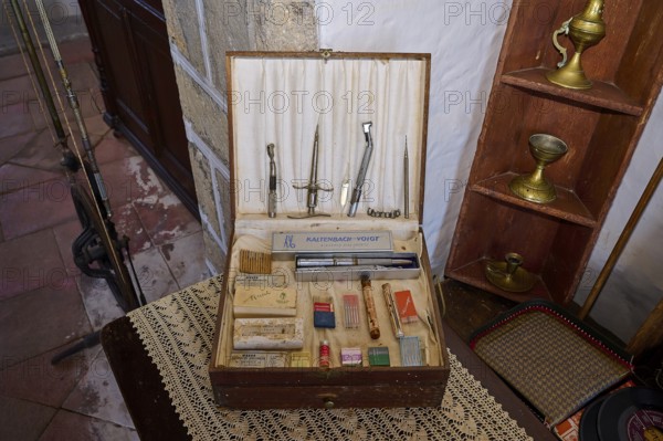 An old toolbox with medical instruments and sewing utensils on an antique wooden shelf, Simantiris House, Chora, main town of Patmos, Patmos, Old Town, Dodecanese, Greek Islands, Greece, Europe