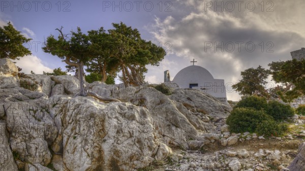 HDR, Small chapel on rocky terrain with trees and cloudy sky in the background, Chapel of Agios Panteleimon, Kastro Monolithou, Monolithos Castle, rock castle, Monolithos village, Rhodes, Dodecanese, Greek Islands, Greece, Europe