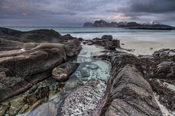 Rocks and beach in front of Bergen, sea, surf, spray, clouds, winter, Flakstadoya, Lofoten, Norway, Europe
