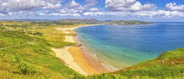 Extensive coastal landscape with golden sandy beaches and blue sea under a cloudy sky, Ballymastocker Bay
