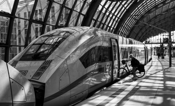 Black and white photograph, traveller with bicycle at Berlin Central Station, Berlin, Germany, Europe