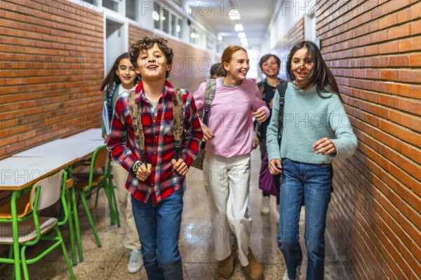 Cheerful students with backpacks rushing through the school hallway, enjoying their break between classes and sharing joyful moments together