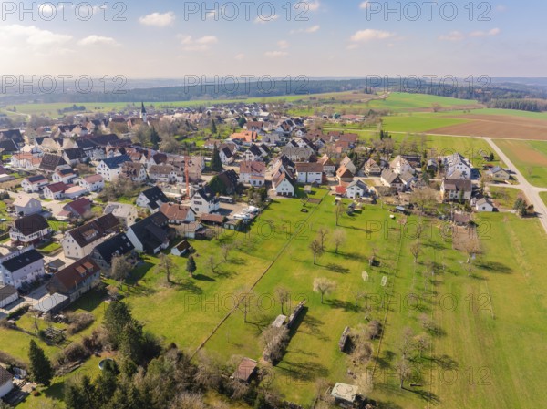 Wide green spaces and scattered houses in a village that stretches through a peaceful landscape under a blue sky, Nagold Hochdorf, district of Calw, Germany, Europe