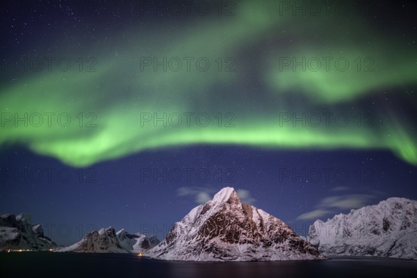 Green northern lights reflected in fjord, steep mountains, aurora borealis, winter, Reine, Moskenesoya, Lofoten, Norway, Europe