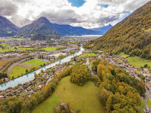Sweeping views of a landscape with river and mountains under dramatic skies in an autumnal setting, Interlaken, Switzerland, Europe