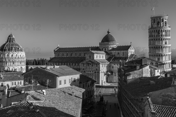 Above the roofs of Pisa, behind the Baptistery, the Cathedral of Santa Maria Assunta and the Leaning Tower, black and white photo, Pisa, Tuscany, Italy, Europe