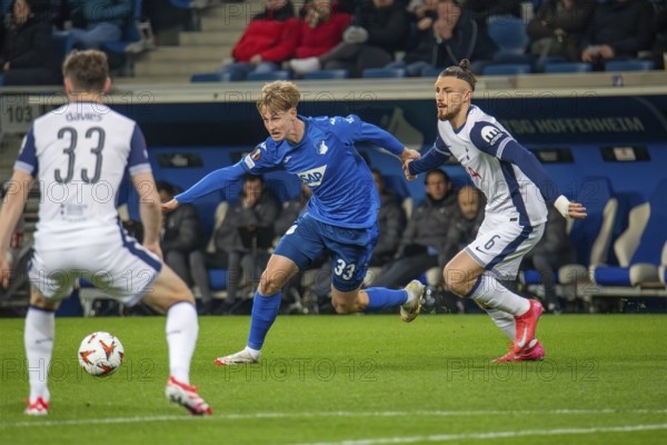 Football UEFA Europa League, 2024/25 season, matchday 7: TSG Hoffenheim v Tottenham Hotspur. Picture: Duel between Max Moerstedt (33, Hoffenheim) and Radu Dragusin (6, Tottenham)