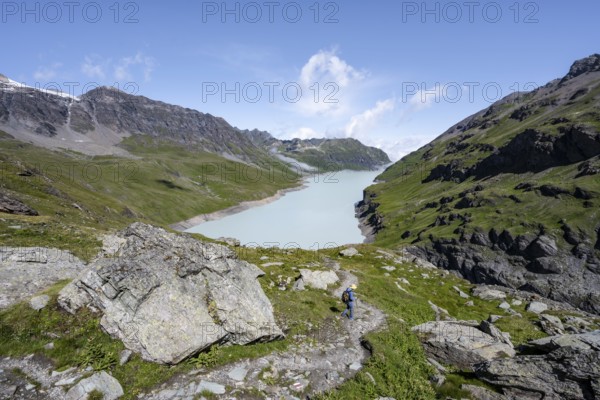 Mountaineer on hiking trail in front of Lac des Dix reservoir, Valais Alps, Valais, Switzerland, Europe