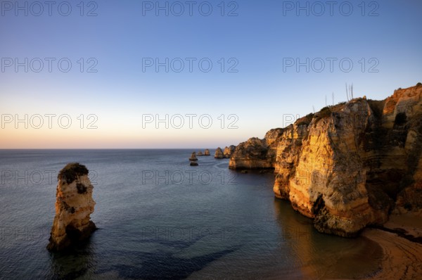 Colourful cliffs and rocks at sunrise on the beach, Praia da Dona Ana, Lagos, cliffs, Atlantic Ocean, Algarve, Portugal, Europe