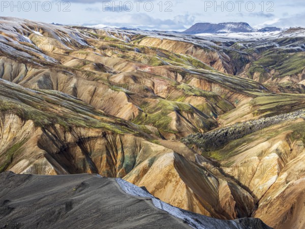 Early snow on the colorful rhyolite mountains, Landmannalaugar, Fjallabak Nature Reserve, Iceland, Europe