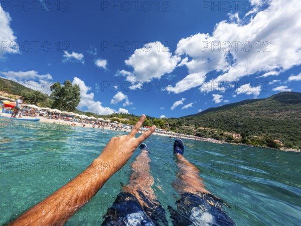 Resting in the sea on the beach in summer of Paralia Mikros Gialos in the south of the island of Lefkada. Greece