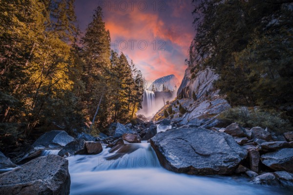 Sunset at Vernal Falls in Yosemite National Park in the water next to the stones, long exposure photo. California, United States, North America