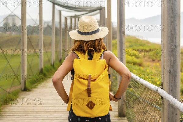 Summer vacation lifestyle. Young and adventurous girl enjoying the summer walking alone along the beach