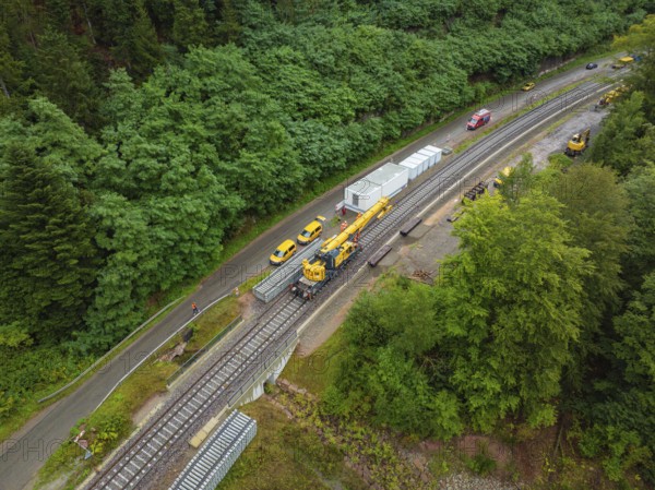 Aerial view of a railway line with longer track, vehicles and construction site workers, surrounded by lush greenery, track construction, Hermann Hessebahn, Calw, Black Forest, Germany, Europe