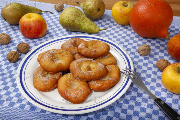 Swabian cuisine, harvest cakes, dessert, dessert, fat baked goods, doughnuts, fried food, lard noodles, arranged on a plate, grandmother's kitchen, regional, home cooking, typical Swabian, classic recipe, traditional cuisine, food photography, autumn atmosphere, apples, pears, nuts, still life, studio, Germany, Europe