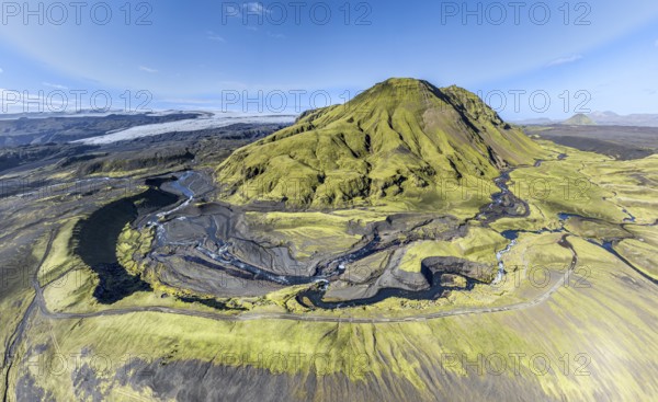 River along road F232 Öldufellsleid, slopes of Mt. Öldufell, moss-covered hill in black lava sand, Mt. Maelifell in the back (right), aerial view, Iceland, Europe
