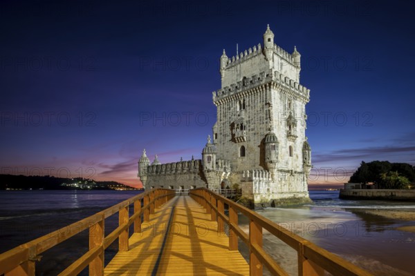 Belem Tower or Tower of St Vincent, famous tourist landmark of Lisboa and tourism attraction, on the bank of the Tagus River (Tejo) after sunset in dusk twilight with dramatic sky. Lisbon, Portugal, Europe