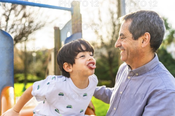 Grandfather and grandson having fun together at the playground, enjoying quality time and creating lasting memories
