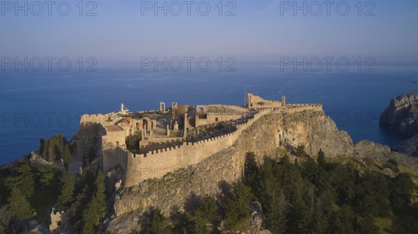 Drone shot, Acropolis of Lindos, Late afternoon light, Historic castle on a cliff above the sea in golden sunlight, Archaeological site, Lindos, Rhodes, Dodecanese, Greek Islands, Greece, Europe