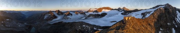 PanoraAtmospheric sunrise in picturesque mountain landscape, alpenglow, aerial view, mountain hut Becherhaus at the summit Becher and glacier Übeltalferner, Stubai Alps, South Tyrol, Italy, Europe