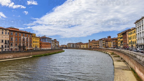 Rows of houses with pastel-coloured facades to the left and right of the River Arno, Pisa, Tuscany, Italy, Europe