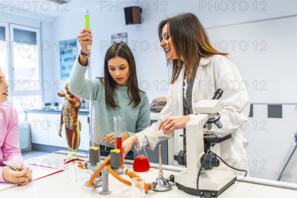 Female teacher assisting student using laboratory equipment during a chemistry experiment in a science classroom
