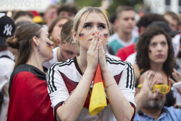 A woman watches the football match in the fan zone at the Brandenburg Tor during the quarter-final match between Germany and Spain at the European Football Championship, Berlin, 05/07/2024