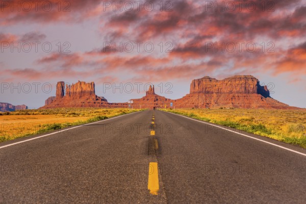 Sunset in the road with its yellow lines of Monument Valley, Utah