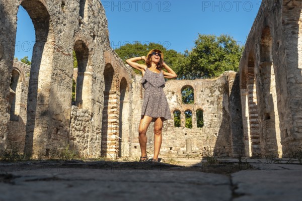 A tourist visiting in Great basilica in the archaeological ruins of Butrint or Butrinto National Park, Albania, Europe