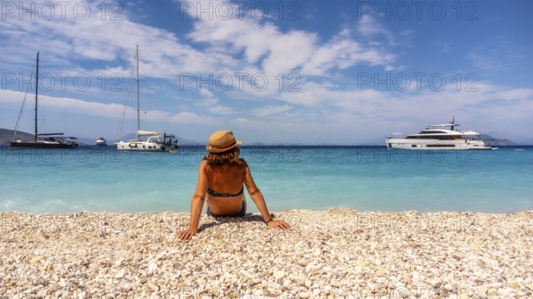 Portrait of a tourist woman resting on the Gidaki Beach on the island of Ithaki or Ithaca in the Ionian sea in the Mediterranean sea of Greece