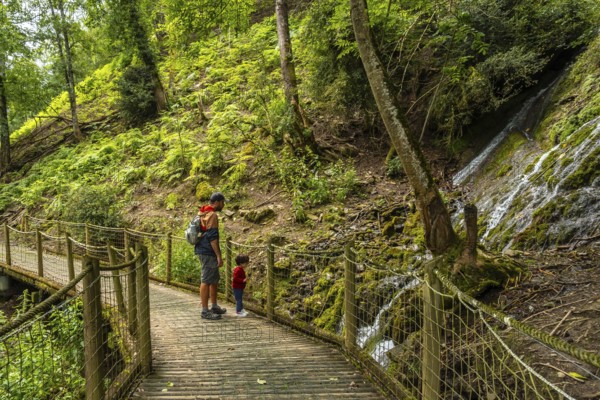 Father and son on a mountain trail in the Borce commune of the French Pyrenees