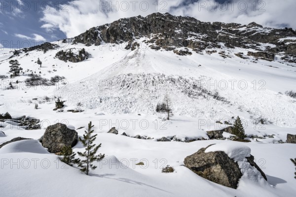 Avalanche cone of a wet snow avalanche on a steep mountain slope with little snow, Bündner Haute Route, Albula Alps, Rhaetian Alps, Grisons, Eastern Switzerland, Switzerland, Europe