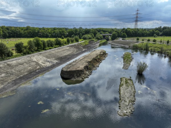Dortmund / Castrop-Rauxel, North Rhine-Westphalia, Germany, river renaturalisation, renaturation of the Emscher, flood retention basin HRB Mengede. A new floodplain landscape is being created at the Emscher-Auen farm, expanding the area for flood protection during heavy rainfall and for biodiversity. The Emscher, which is currently straightened, will be given curves again and can meander through its new floodplain. Following the construction of a parallel sewer, the Emscher has been completely free of wastewater since 2022. The river was previously an open, above-ground combined sewer with rainwater and wastewater. The A45 motorway in the background, Europe