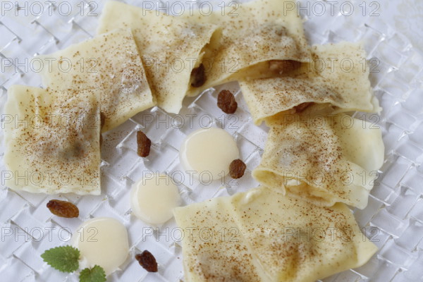 Swabian cuisine, apple dumplings, apple in pasta dough, sweet dish, dessert, vanilla sauce, cinnamon, served on a plate, grandmother's kitchen, regional, home cooking, typical Swabian, classic recipe, traditional cuisine, food photography, studio, Germany, Europe