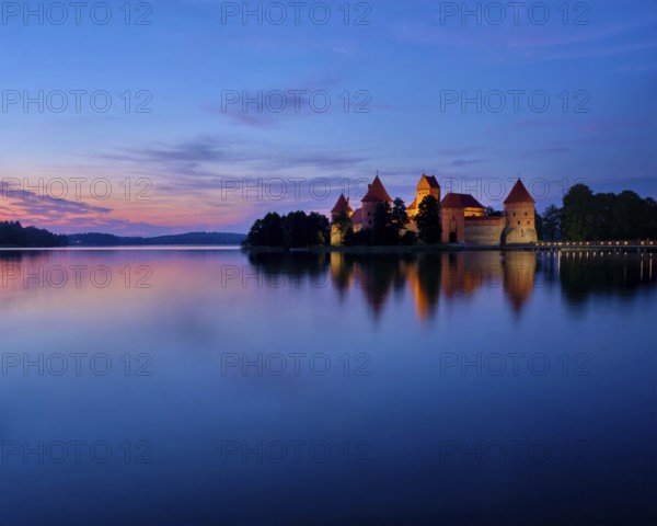 Evening view of Trakai Island Castle in lake Galve illuminated in the night, Lithuania, Europe