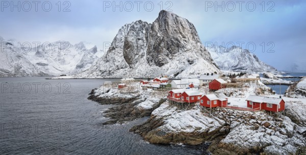 Panorama of famous tourist attraction Hamnoy fishing village on Lofoten Islands, Norway with red rorbu houses in winter