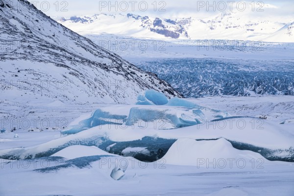 Snow-covered icebergs in the glacier lagoon Fjallsarlon, Breidamerkurjökull in the background, Sudurland Iceland