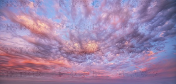 Atmospheric sky with luminous clouds at sunrise