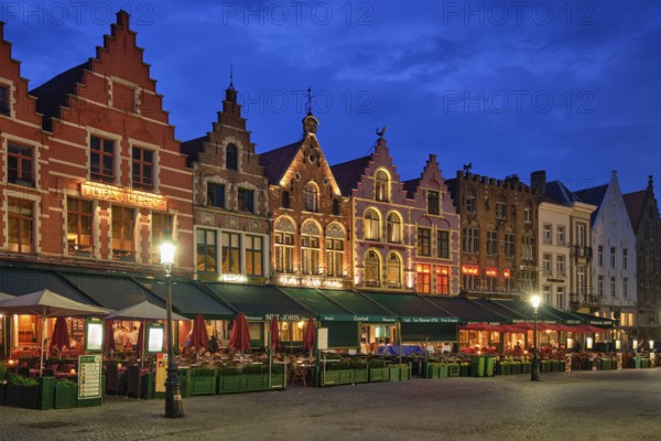 Bruges, Belgium, May 29, 2018: Bruges Grote markt square famous tourist place with many cafe and restaurants in the evening night twilight, Europe