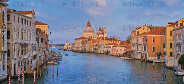 Panorama of Venice Grand Canal with boats and Santa Maria della Salute church on sunset from Ponte dell'Accademia bridge. Venice, Italy, Europe