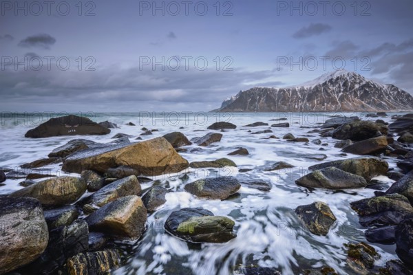 Rocky coast of fjord of Norwegian sea in winter. Skagsanden beach, Lofoten islands, Norway, Europe