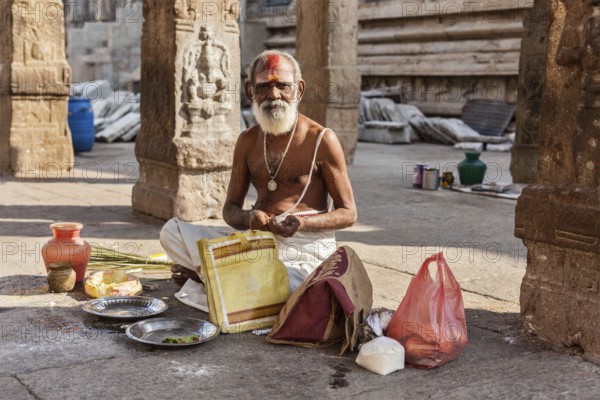 MADURAI, INDIA, FEBRUARY 16, 2013: Indian brahmin (traditional Hindu society) priest in famous Meenakshi Amman Temple, historic Hindu temple located in temple city Madurai