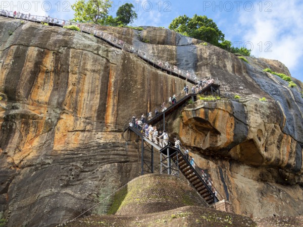 Visitors climb the stairs at Sigiriya Rock, Sri Lanka, Asia