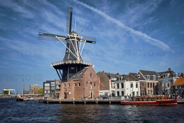 View of Harlem landmark windmill De Adriaan on Spaarne river. Harlem, Netherlands